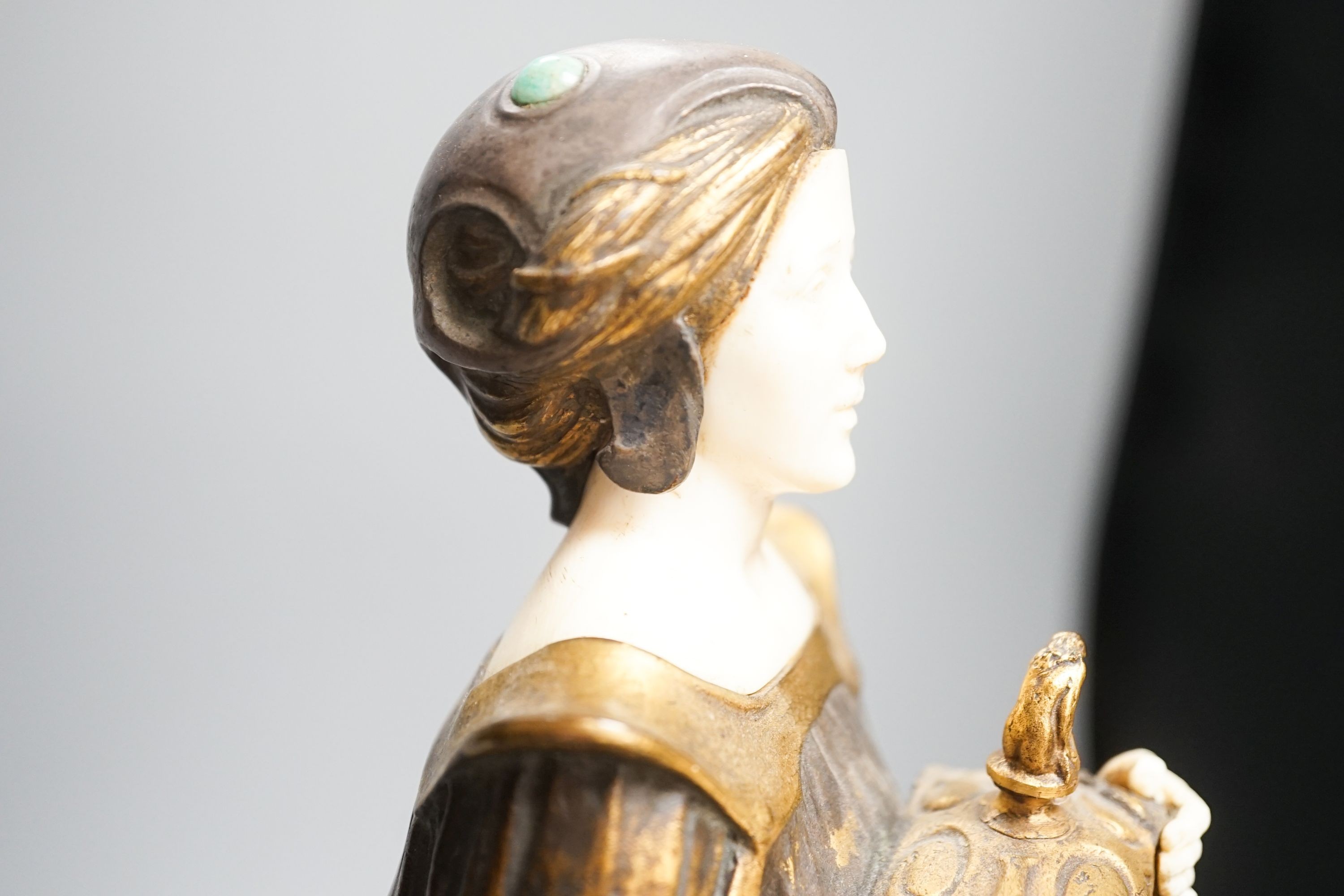 A German Art Nouveau bronze and ivory figure of Pandora, with inset carved ivory head and hands on polished stone and cut wood base, signed F. Jahn, 41cm high